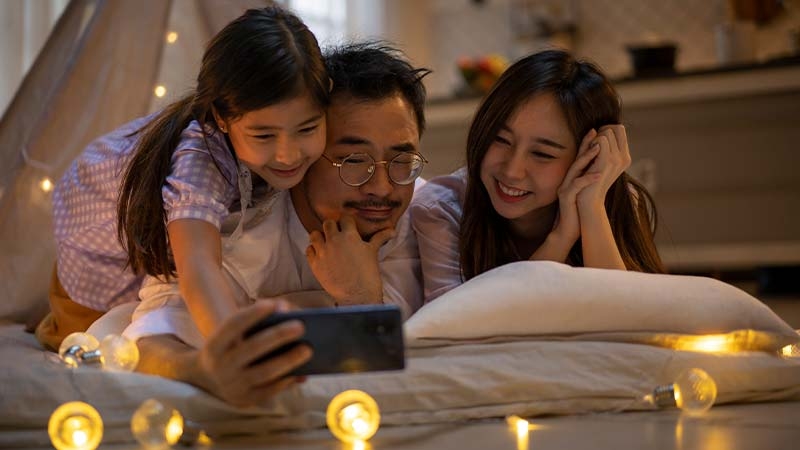 A person and person taking a selfie with a child