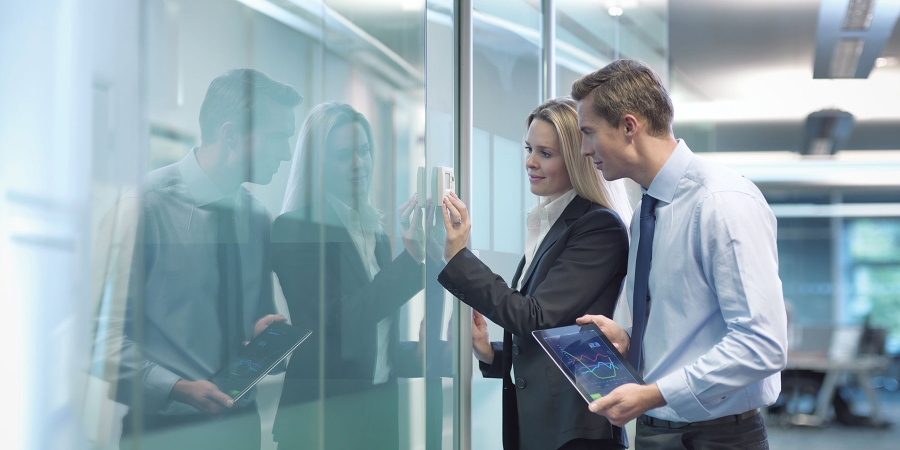 Two people in office doing biometric