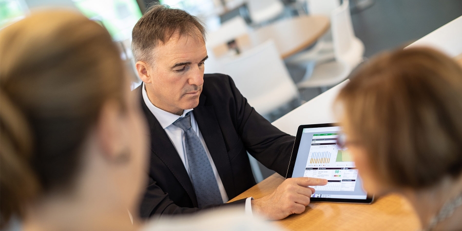 A buisnessman Showing something in his tablet