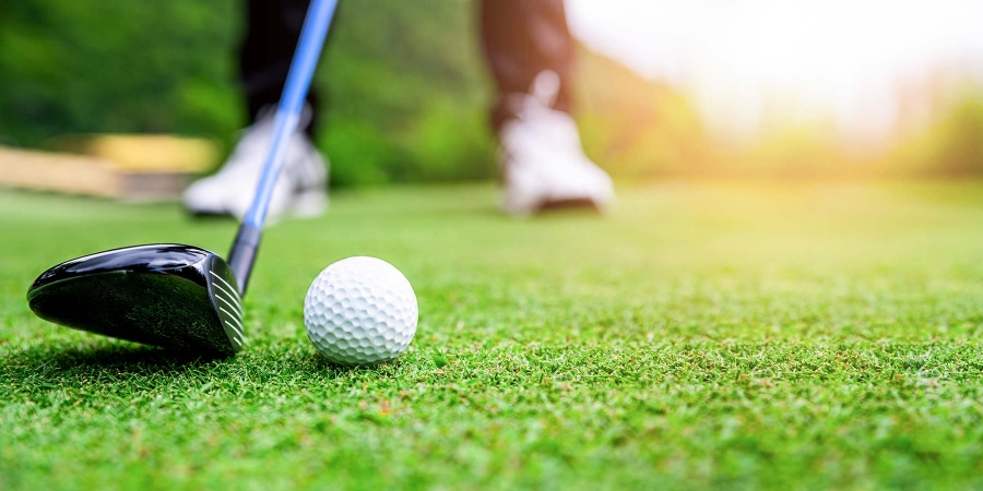 Closeup of a golf ball and stick