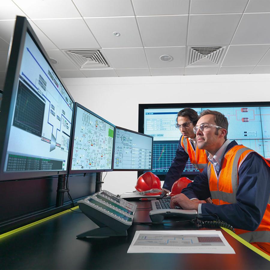 Operators in power station control room working with technical challenges, sustainability reporting.