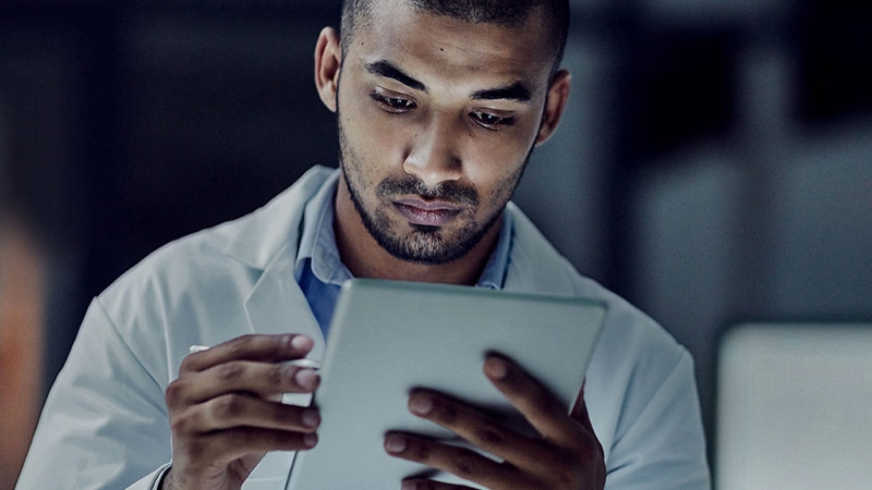 a male technician holding a tablet