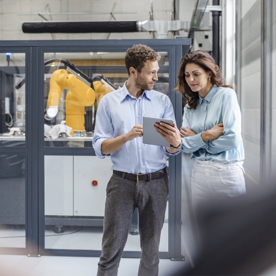 man and women in robots industry with tablet