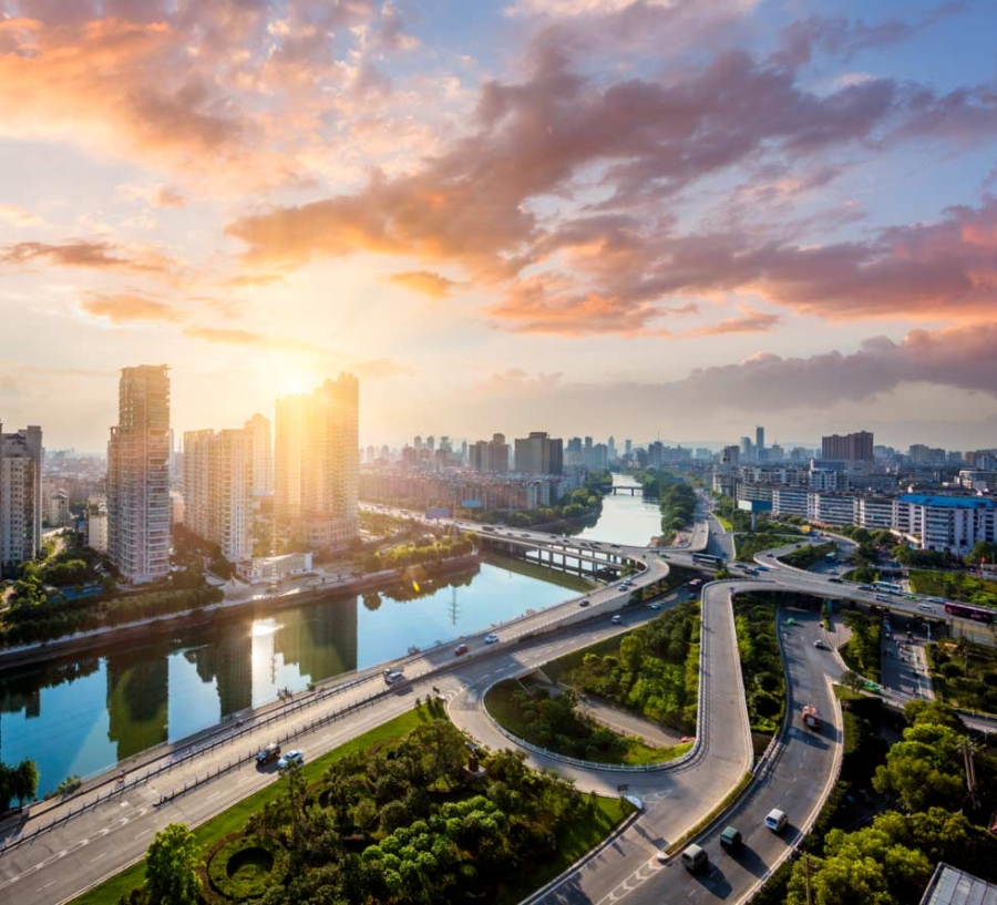 Aerial view at sunset of the city traffic in Megacity Highway of Shanghai China, a smart city transportation.