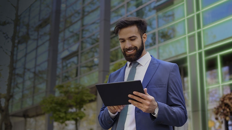 A Man smiling while using tablet