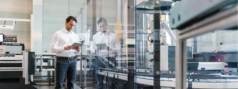 Man with tablet in modern factory.