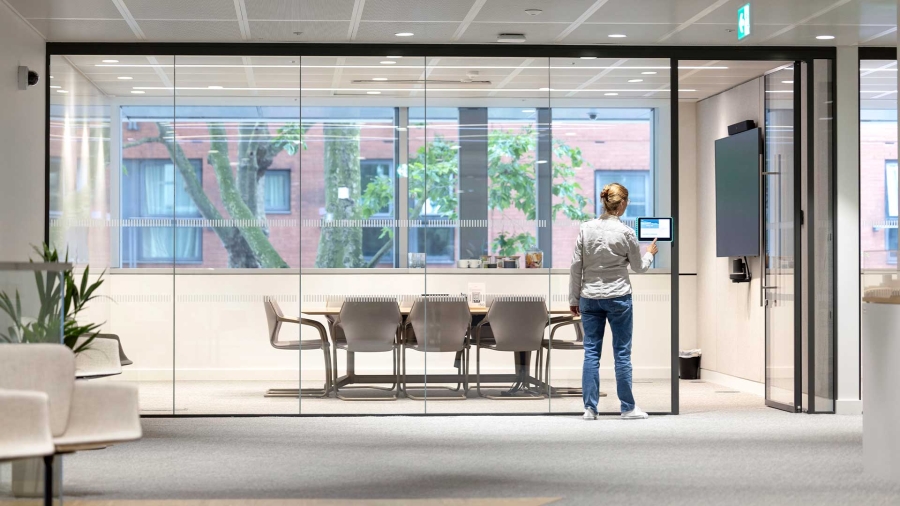 A person standing in front of a glass wall