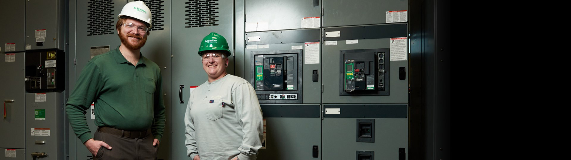 Schneider Electric employees with award logos for Military Friendly Employers 2024