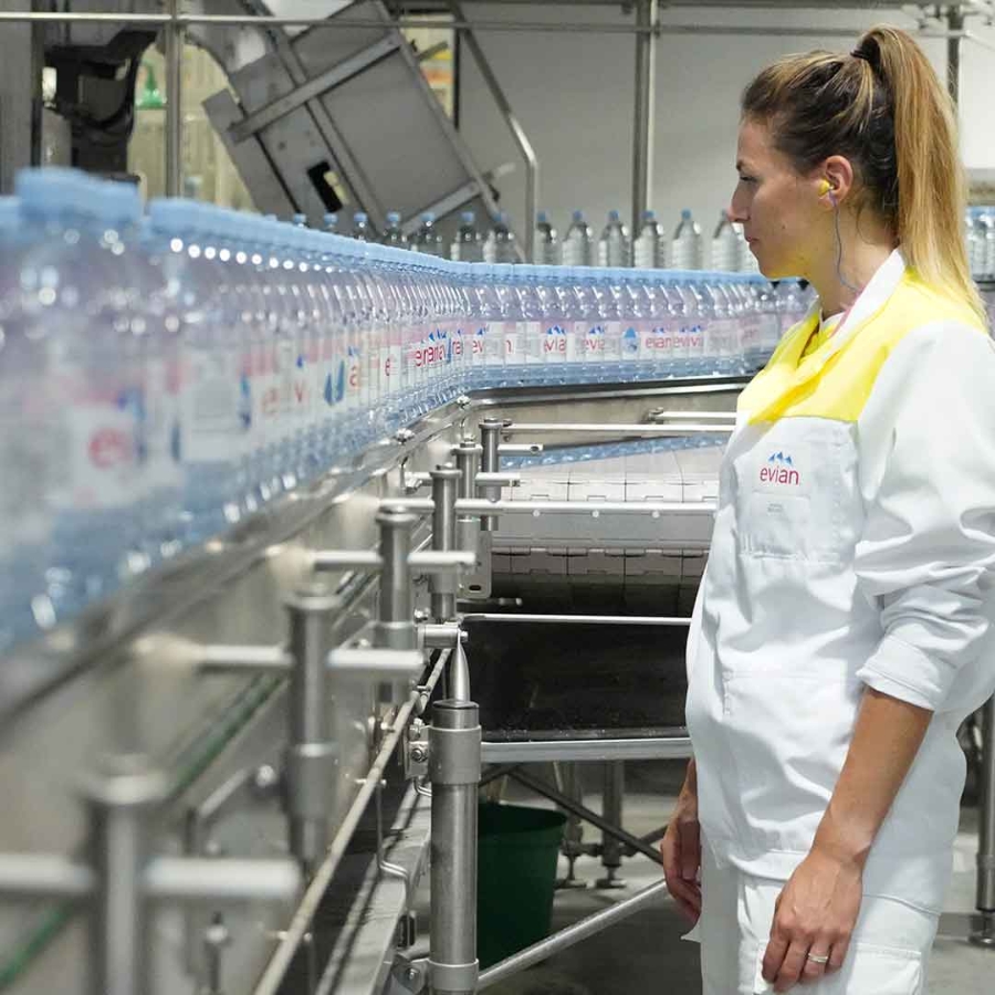 lady is looking at electrical installation of bottling process