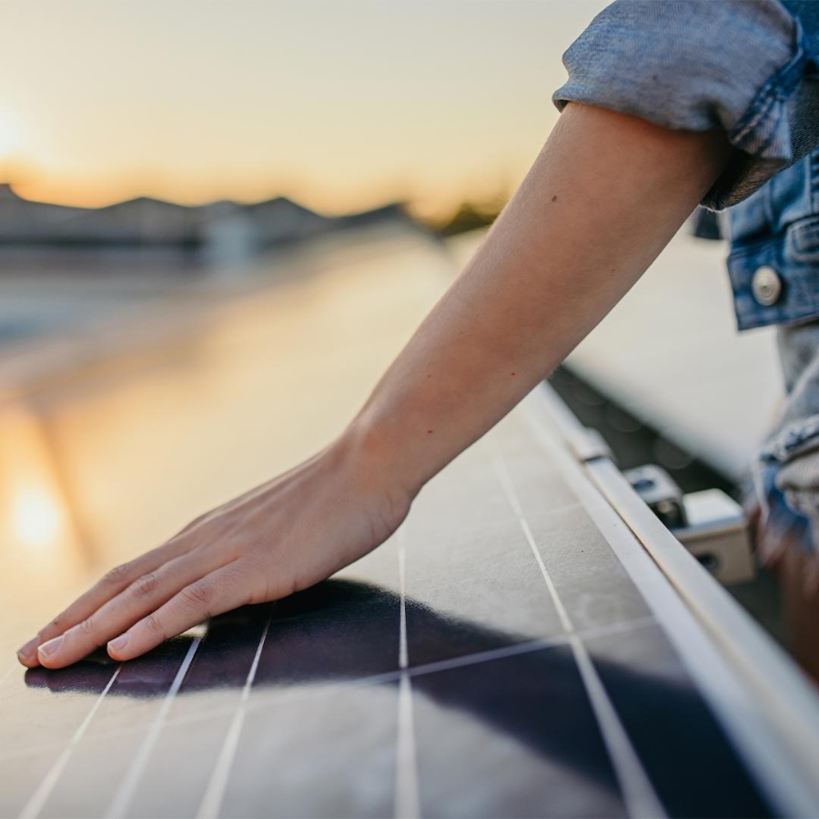 A person touching a solar panel