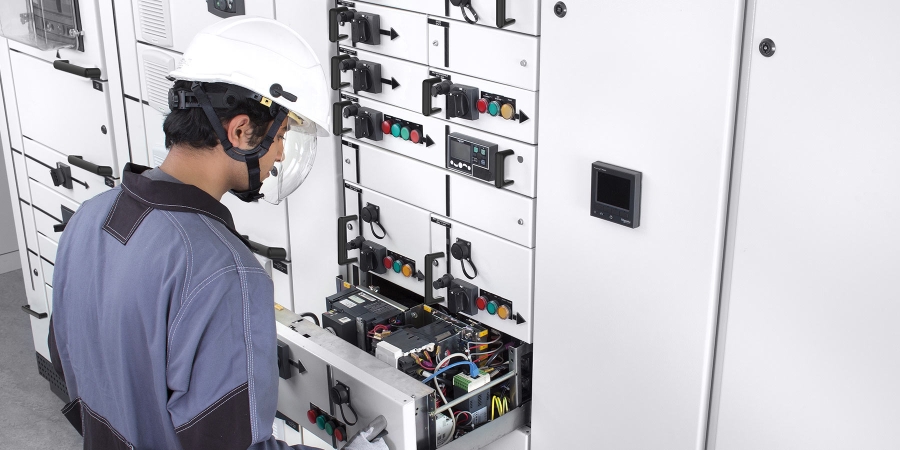 man wearing white helmet working in the control room