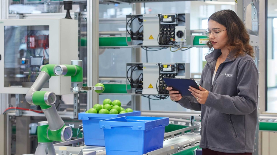 A person holding a tablet in a factory