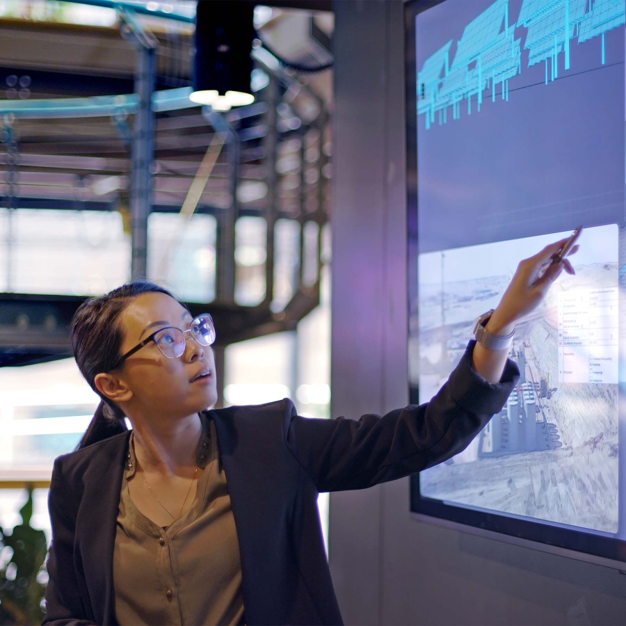 woman in glasses touching screen