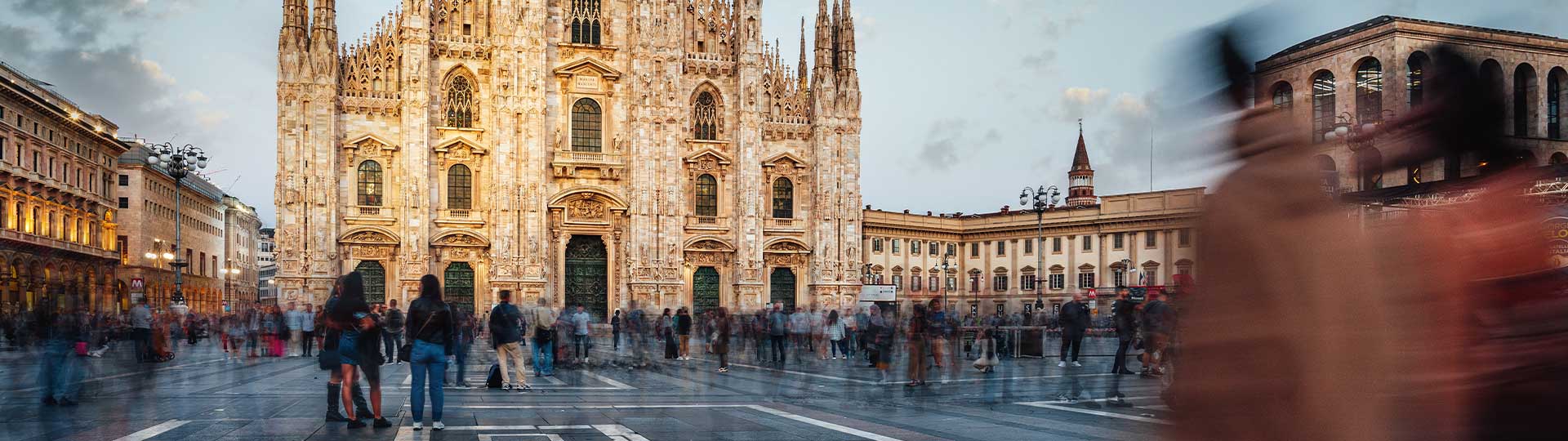 A group of people walking in front of a building