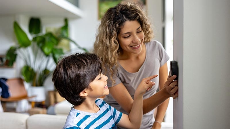 A person pointing at a child's device