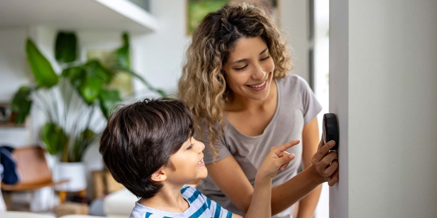 A person pointing at a phone to a child