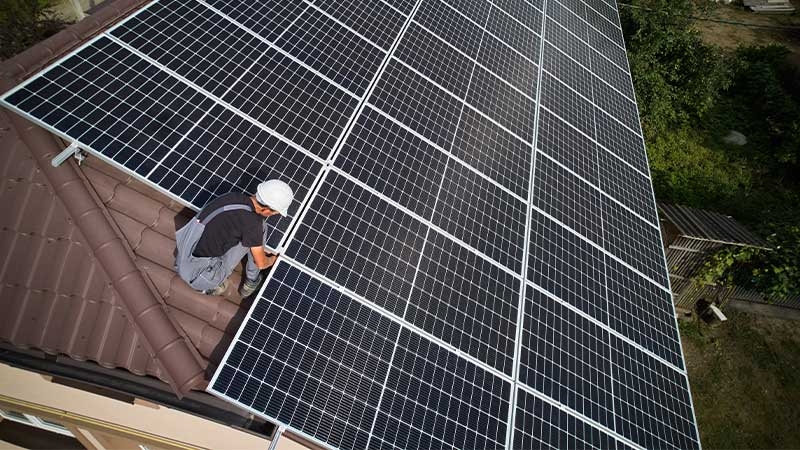 A person working on a solar panel