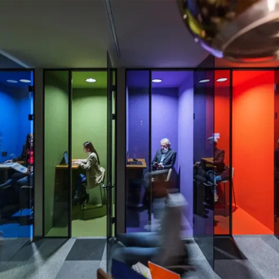 A group of people in a room with colorful walls