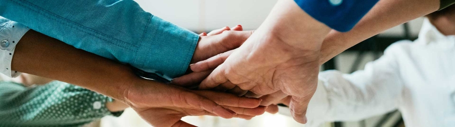 A close-up of hands holding each other