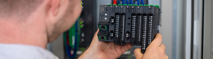 A hand holding a stack of electronic components