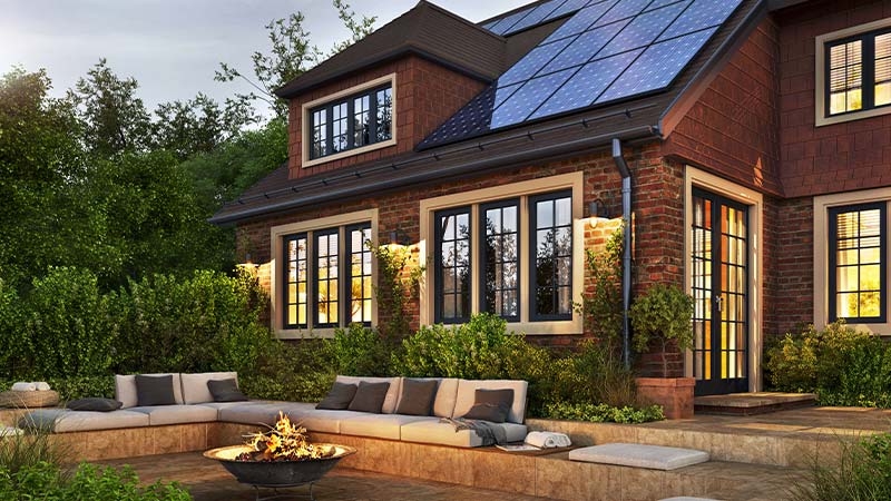 A house with a fire pit and a solar panel on the roof