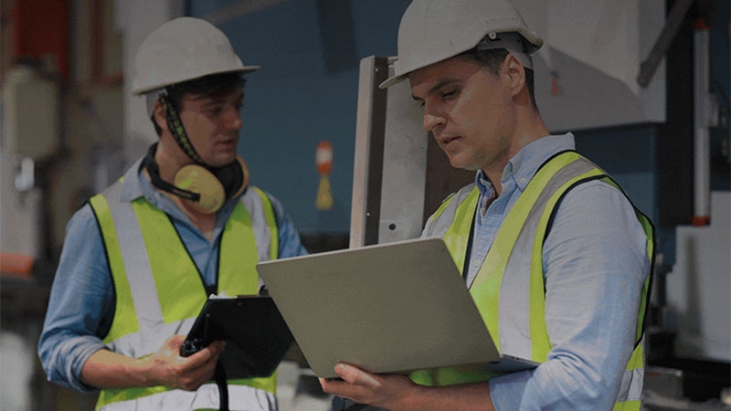 A few men wearing safety vests and helmets