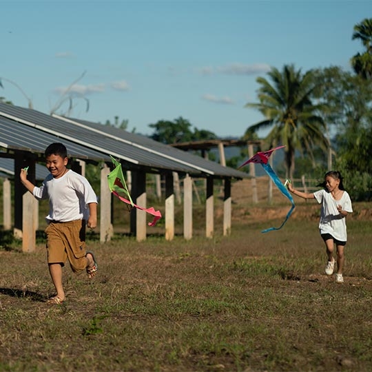 A child and child running with kites