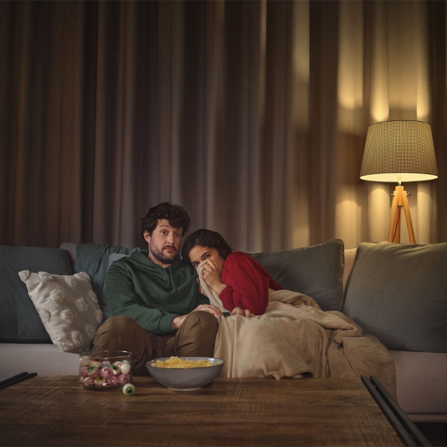 man and woman watching a movie in the living room