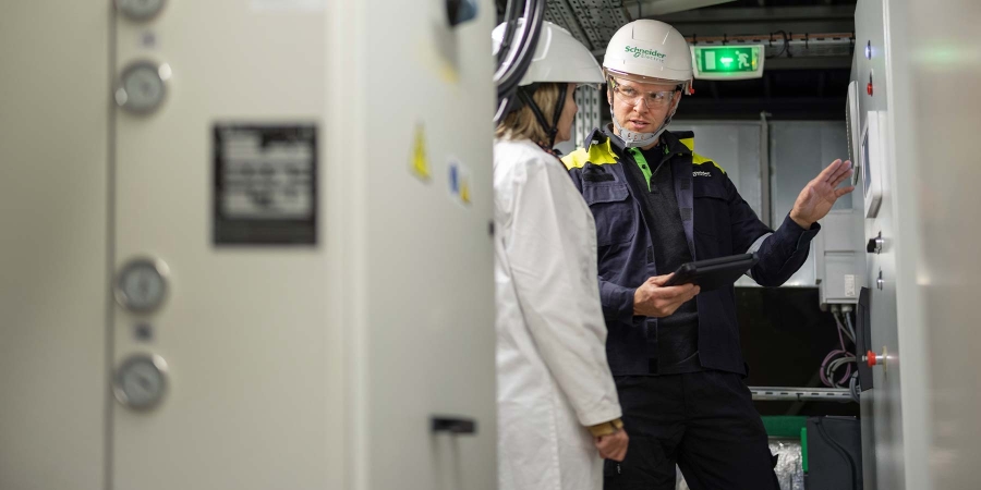 A person and person in white coats and helmets