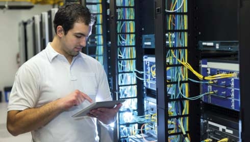 Man on tablet using data centre operations software