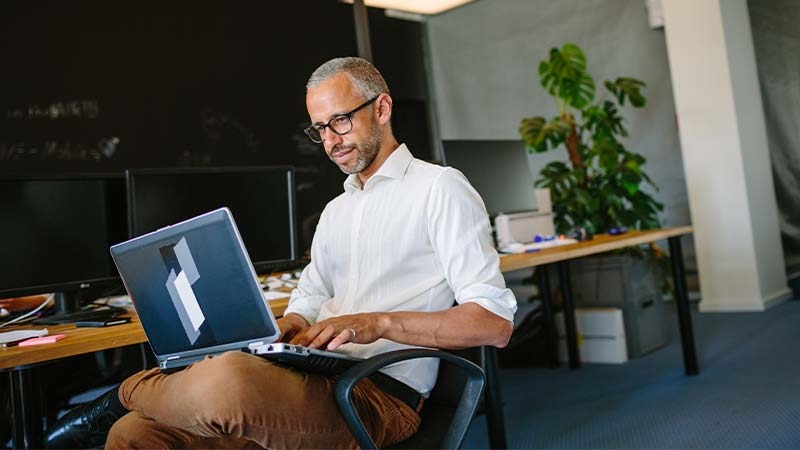 A person sitting in a chair using a computer